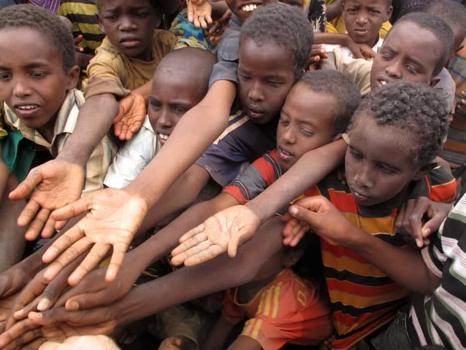 Hungry children stretch out their hands at a Somalian refugee camp in 2011. Sadik Gulec/Shutterstock